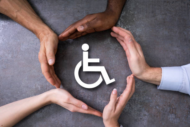 Close-up Of A Hands Protecting Disabled Handicap Icon Close-up Of A Hands Protecting Disabled Handicap Icon